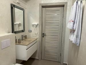 a bathroom with a sink and a toilet and a mirror at Alecsa 1 Luxury Residence in Mamaia +34 photos