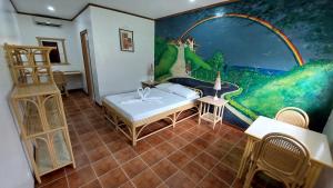 a room with a painting on the wall and a bed at Seaview Moonrise Café in Alcoy