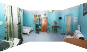 a living room with blue walls and a bedroom at hotel de la bonnaventure in Mazangé