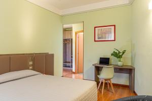 A bed or beds in a room at Hotel Ziò Imola