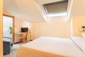A bed or beds in a room at Hotel Ziò Imola