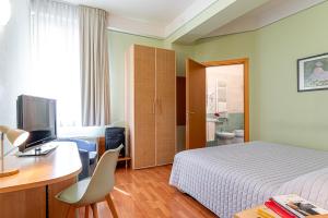 A bed or beds in a room at Hotel Ziò Imola