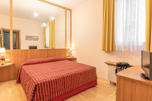 A bed or beds in a room at Hotel Ziò Imola