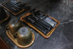 a tray with two tea pots on a table at The Melatonin Hostel - Whole Home แบบเหมาหลัง in Hat Yai