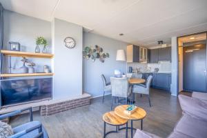 a living room with a couch and a table at Appartementencomplex Juliana 156 in De Koog