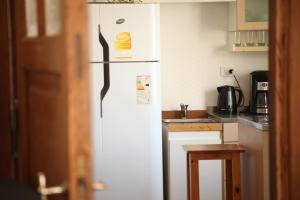 a white refrigerator freezer sitting in a kitchen at La Casona, vistas al boulevard in La Plata +8 photos