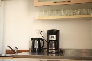 a coffee maker sitting on a counter in a kitchen at La Casona, vistas al boulevard in La Plata