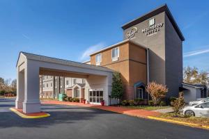 a front view of a hotel with a parking lot at MainStay Suites Lebanon - Nashville Area in Lebanon