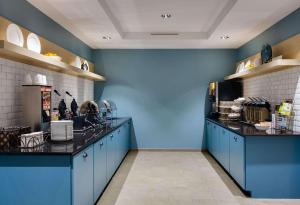 a kitchen with blue walls and a counter top at Country Inn & Suites by Radisson, Springfield Southeast in Springfield
