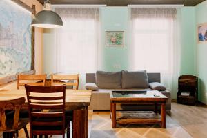 a living room with a couch and a table at Rakvere Vanalinna Apartment in Rakvere