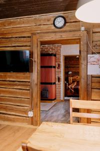 a room with a clock on the wall and a door at Rakvere Vanalinna Apartment in Rakvere