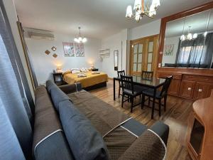 a living room with a couch and a table at Rooms Pontones in Madrid