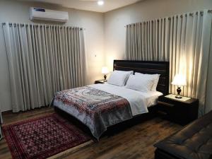 a bedroom with a bed and a couch at Comfort Guest House in Karachi