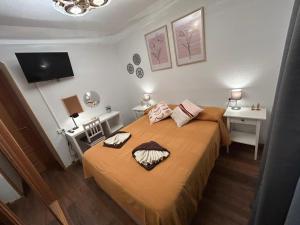 a bedroom with a bed and two tables and a tv at Rooms Pontones in Madrid +19 photos