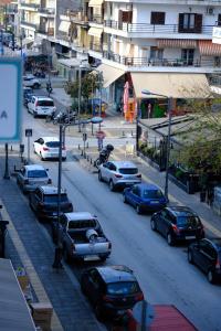 a busy city street with cars parked on the road at Eva House 2 in Drama