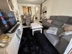 a living room with a couch and a tv at Home S&F- Algorfa in Algorfa
