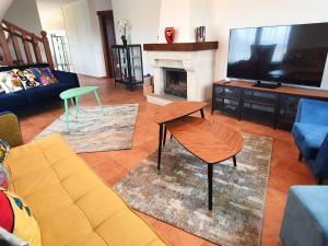a living room with a couch and a tv at La Bergerie del Uncal VV-2915-AS in Arriondas