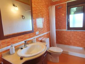 a bathroom with a sink and a toilet and a mirror at La Bergerie del Uncal VV-2915-AS in Arriondas +42 photos