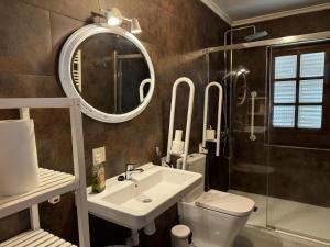 a bathroom with a sink and a toilet and a mirror at Casa Vaqueiro Llanes VV-1727-AS in Llanes +41 photos