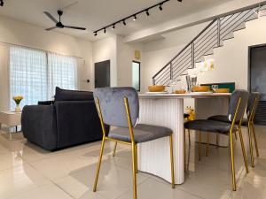a living room with a bar with chairs and a couch at Corner House Puchong 18 pax BBQ Kid Friendly in Puchong
