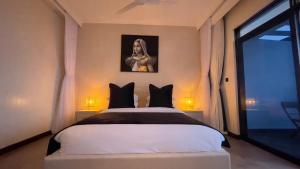 a bedroom with a large white bed with two lamps at Hayce Residence Ocean View Apartment in Kilifi +55 photos