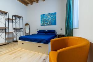 a bedroom with a bed and a chair at Al Merlo da Diego in Cagliari
