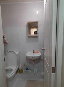 a small bathroom with a toilet and a sink at Aunt & Niece Condotel 2 Bedroom in Cebu City