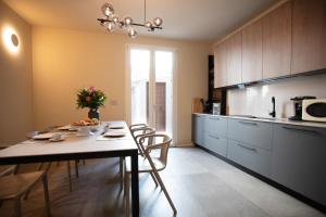 a kitchen with a table and chairs in a room at Villa Marina Blu by Le Dune Villas in Porto Cesareo