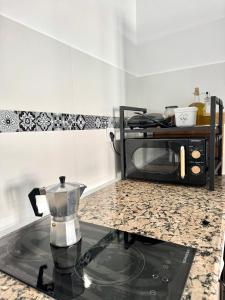 a kitchen with a counter top with a microwave at Casa Celia in El Bosque
