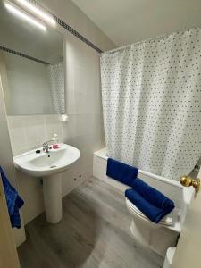 a bathroom with a sink and a toilet and a mirror at Casa Celia in El Bosque