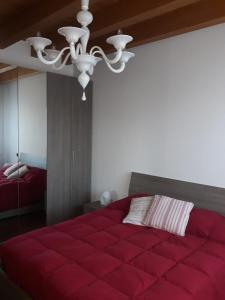 a bedroom with a large red bed with a ceiling at Villamamaeli in Venice-Lido +83 photos