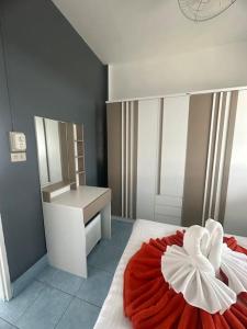 a bedroom with a red and white bed with a sink at P&I Group Home 4 Karon beach in Karon Beach +28 photos