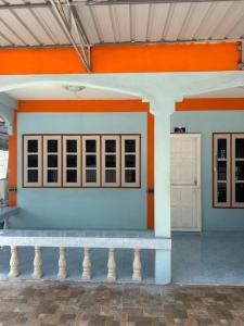 a building with a bench in front of it at P&I Group Home 4 Karon beach in Karon Beach