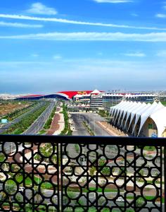 a view of a city from a balcony of a building at Yas Island Rotana Abu Dhabi in Abu Dhabi