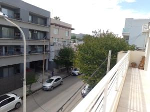 an apartment balcony with cars parked in a parking lot at Anita in Tandil +3 photos