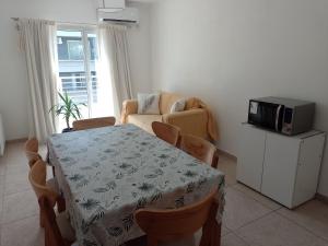 a living room with a table and a microwave at Anita in Tandil