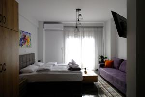 a bedroom with a bed and a couch at Blue House 1 in Drama