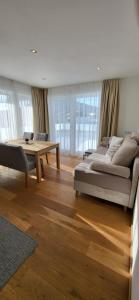 a living room with a bed and a table at Villa Juwel in Altenmarkt im Pongau