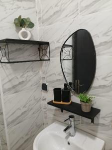 a bathroom with a mirror and a sink at Appartement Cosy et Familial in Safi +17 photos