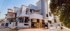 a white building with colorful doors on a street at Udaipur Villa 2 Entire 4 bhk Villa in Udaipur