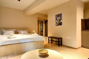 a bedroom with a large bed and a table at Central Studio Apartments by Parkside Boutique in Skopje