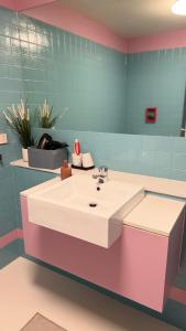 a bathroom with a white sink and blue tiles at Emporium-Melbourne Central-City view in shopping hotspots - Pokemon in Melbourne +43 photos
