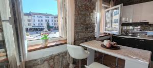 a kitchen with a counter and a large window at L'angolo di Filippo I piano in Cividale del Friuli