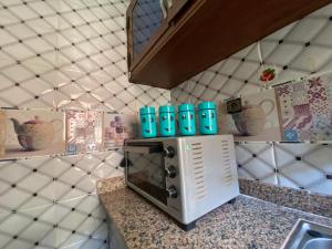 a microwave on a counter in a kitchen at The Caring Corner in Agadir +17 photos