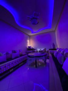 a purple room with a couch and a table at The Caring Corner in Agadir