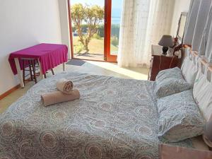 a bedroom with a bed with a towel on it at Family beachfront cottage in Tergniet