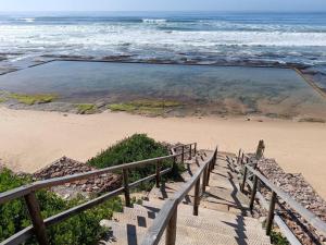 a set of stairs leading down to the beach at Family beachfront cottage in Tergniet