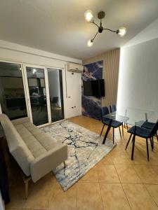 a living room with a couch and a glass table at Beach Front Superior Apartment Blue Marine in Durrës