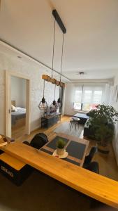 a large living room with a table and chairs at Apartment Unamare in Belgrade