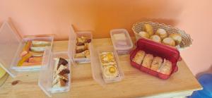 a table with four plastic containers filled with different types of food at Cantinho da Tia Lucia in Beberibe